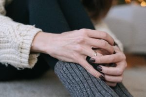 woman holding wedding ring in her hand