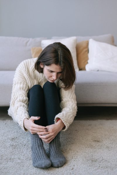 Sad woman sitting on floor