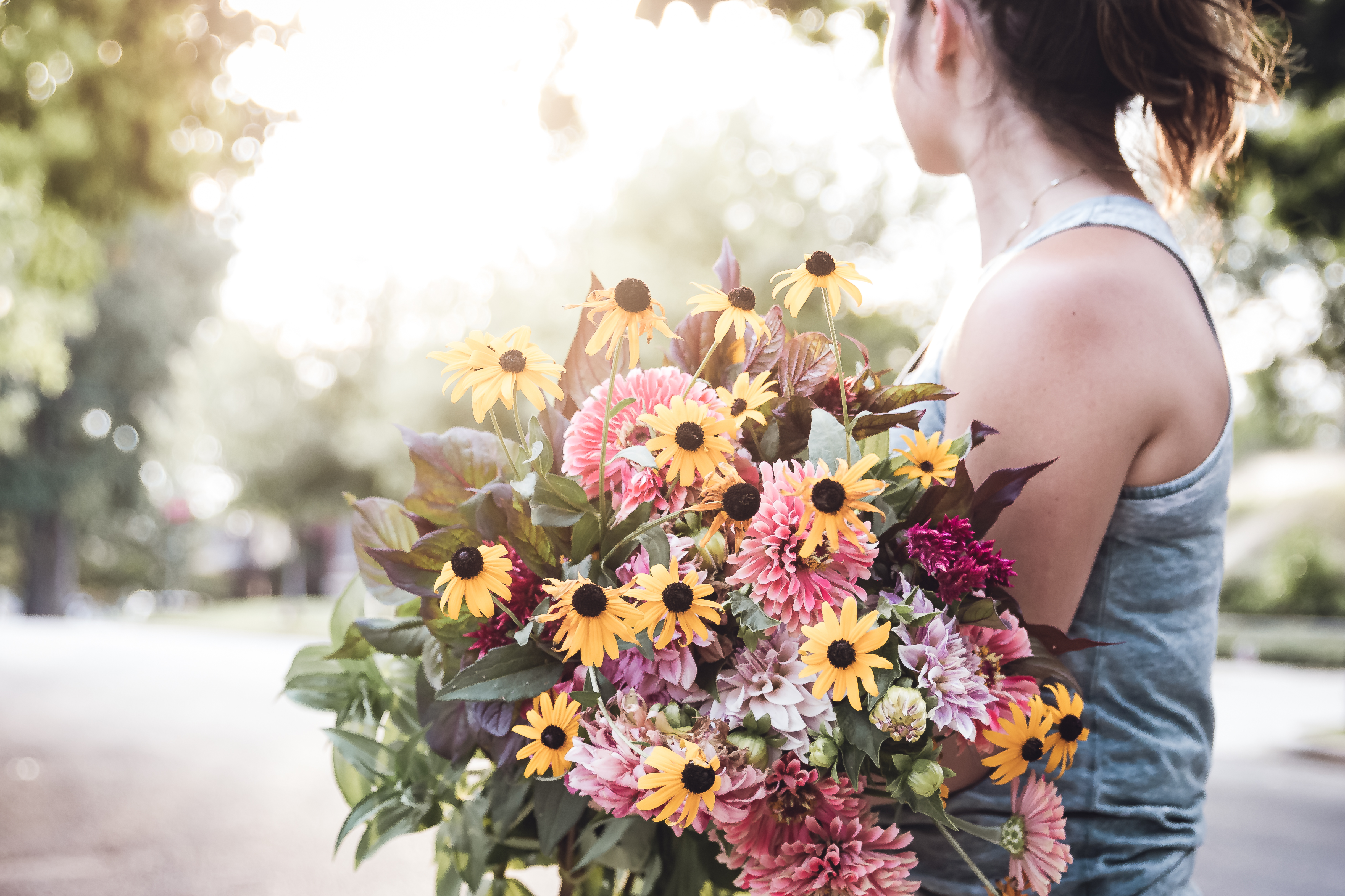 young lady holding a beautiful bouquet of flowers