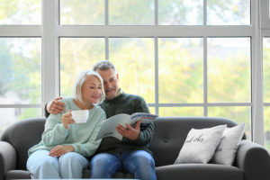 Couple sitting on couch reading together