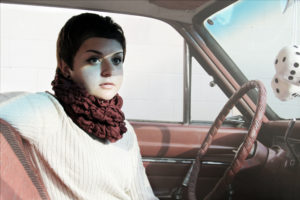 picture of girl in a car looking like she is thinking hard