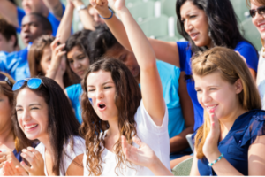 people cheering at a high school event