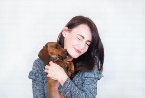 woman with dog licking her face