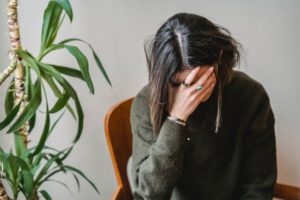 woman with headache triggered by trauma