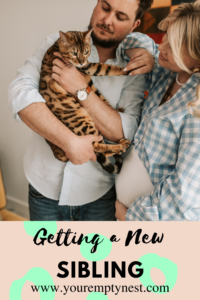 Picture of a pregnant young couple with cat