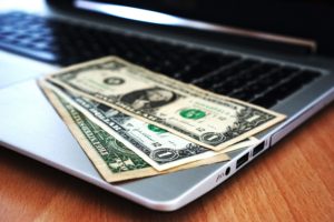 picture of three dollar bills on a desk