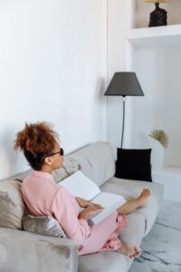woman on couch studying